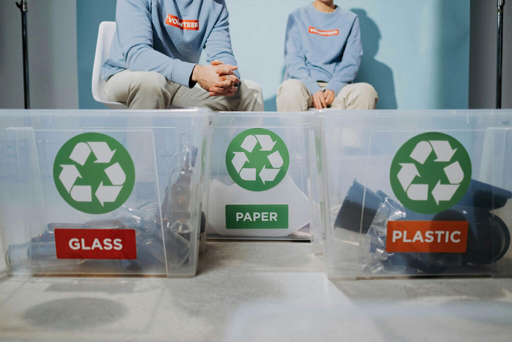 Sustainable-Lifestyle A family sorting recycling bins in their kitchen