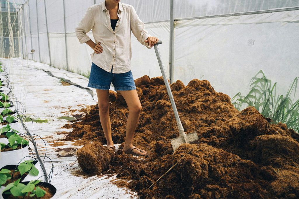 A wooden compost bin filled with organic waste
